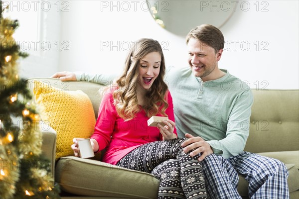 Young woman surprised with Christmas gift