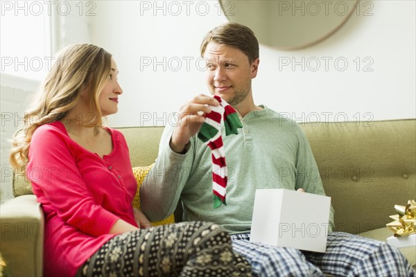 Man holding unwanted Christmas gift
