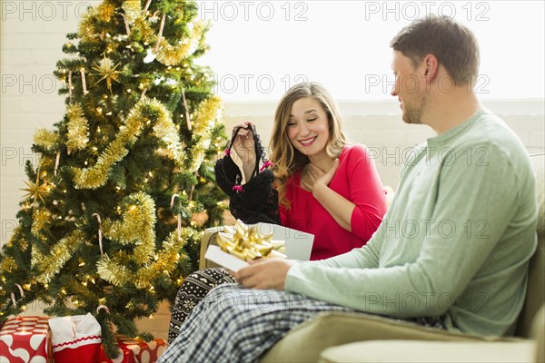 Young woman surprised with Christmas gift