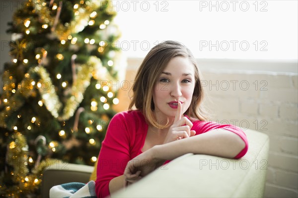 Portrait of woman with finger on lips