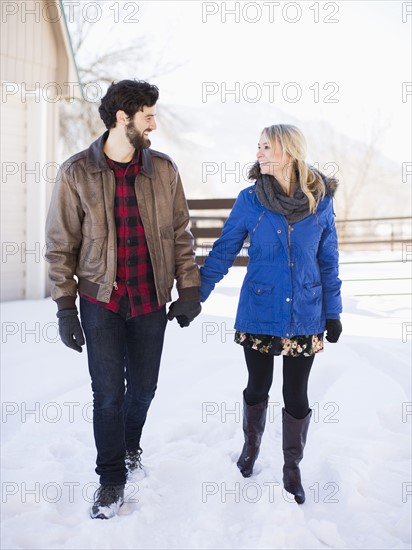 Young couple walking outdoors in winter