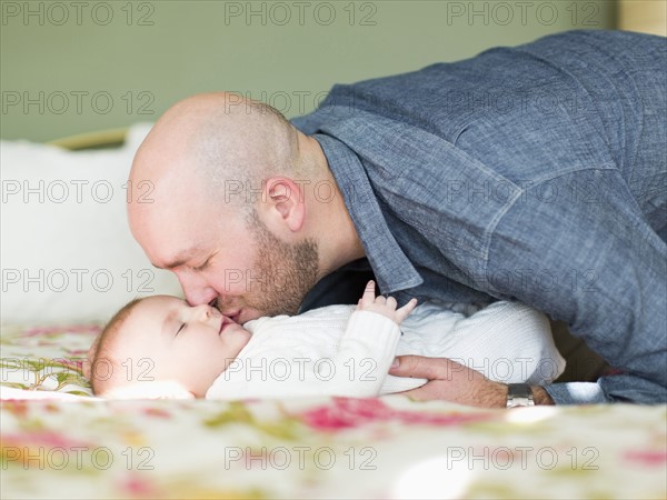 Studio shot of father kissing his son (2-5 months)