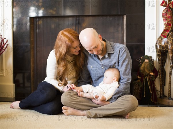 Parents watching their baby (2-5 months) sleeping