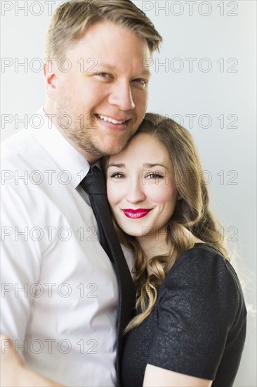 Studio portrait of young couple smiling