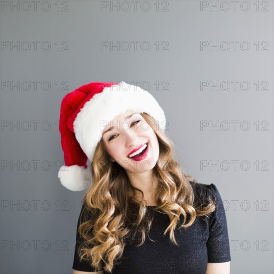 Studio portrait of woman wearing Santa hat