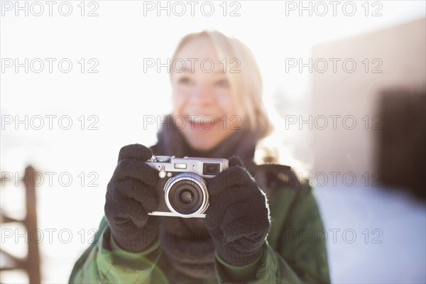 Woman holding old-fashioned camera