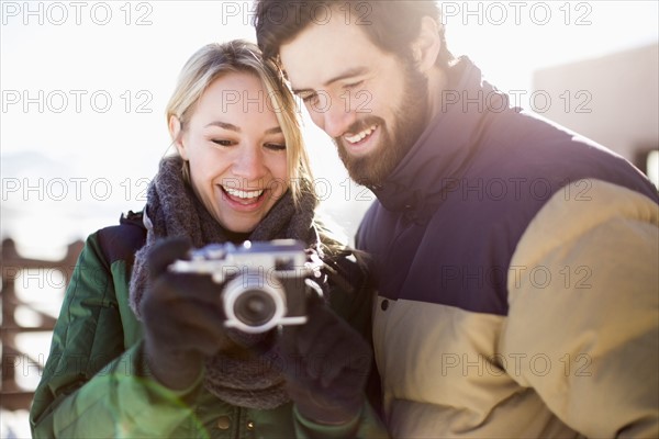 Couple looking at old-fashioned camera