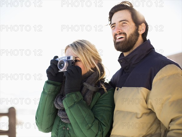 Couple photographing winter landscape