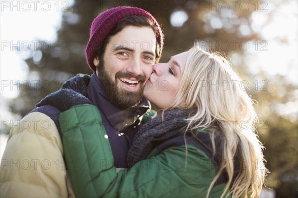 Woman kissing man's cheek