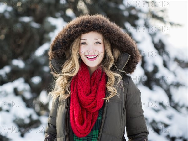 Portrait of woman wearing red scarf smiling outdoors