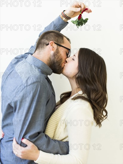 Couple kissing under mistletoe