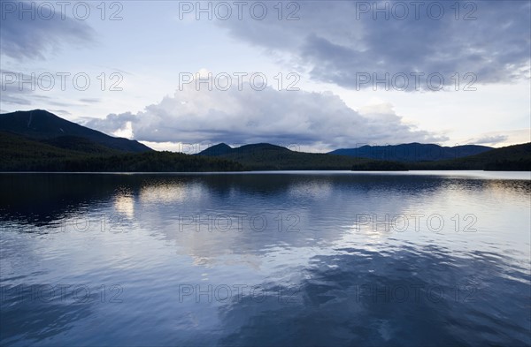 Clouds reflecting in lake at dusk