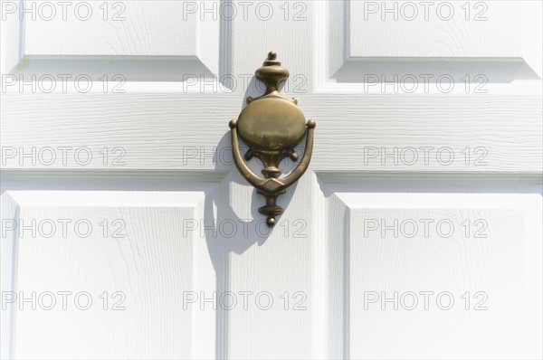 Close-up of white door with knocker