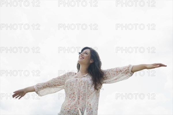 Happy woman against sky