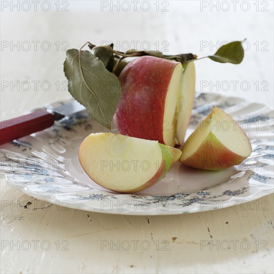 Studio shot of sliced apple on plate.