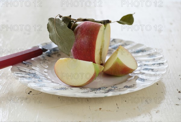 Studio shot of sliced apple on plate.