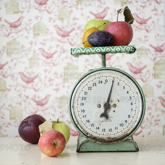 Studio shot of fruits on weight scale.