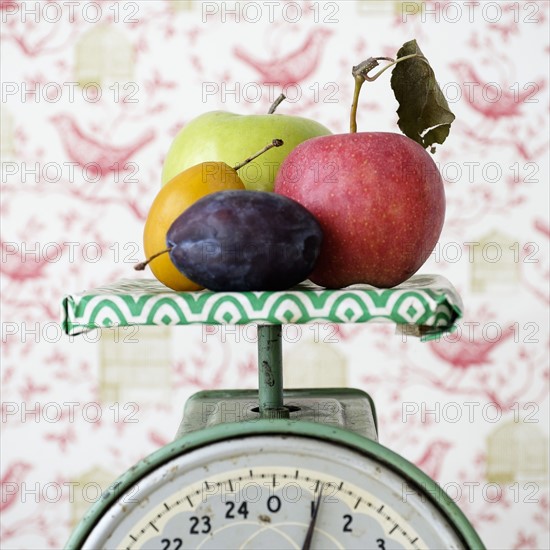 Studio shot of fruits on weight scale.