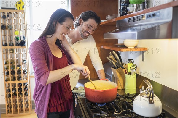 Happy couple preparing dinner.