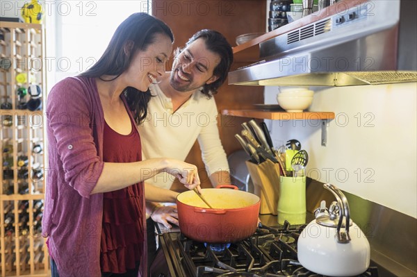 Happy couple preparing dinner.