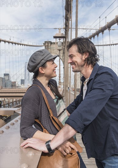 Happy couple on Brooklyn Bridge. Brooklyn, New York.