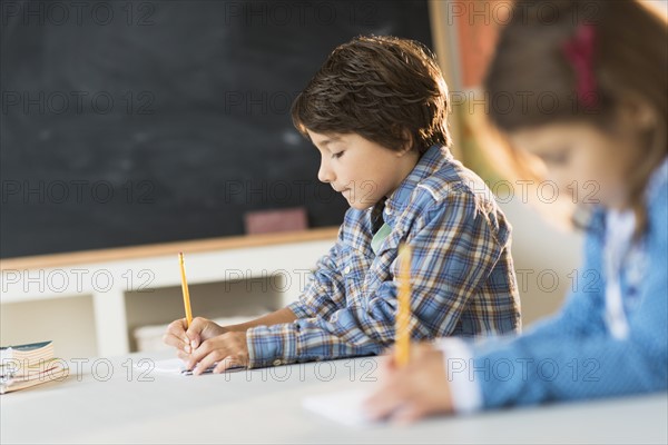 Pupils (6-7) learning in classroom.