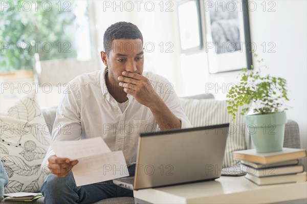 Man paying bills online.