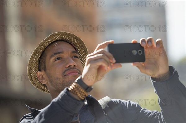 Man taking photo on street. .