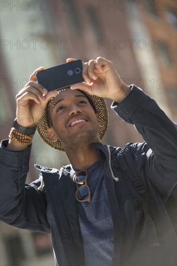 Man taking photo on street. .