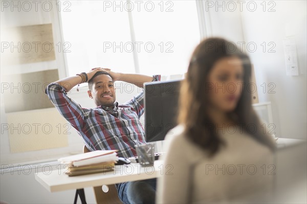 Businessman relaxing in office.