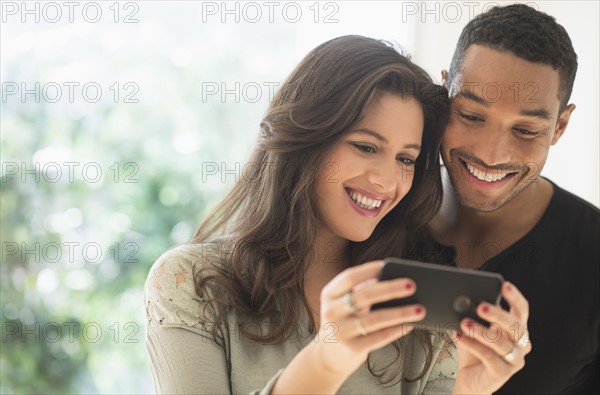 Couple looking at smartphone.