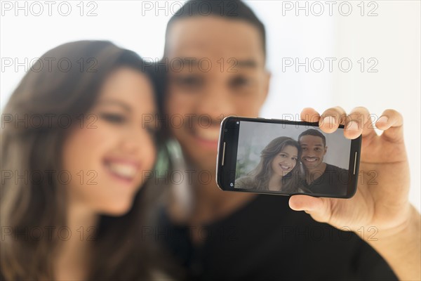 Happy couple taking selfie. .