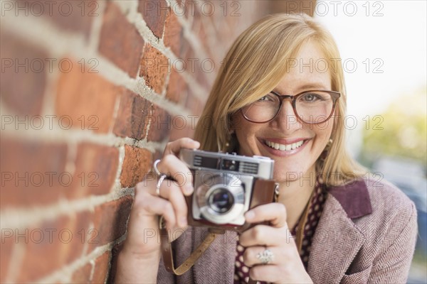 Woman holding vintage camera. .