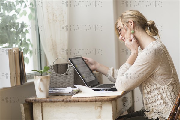 Woman sitting at desk and contemplating. .