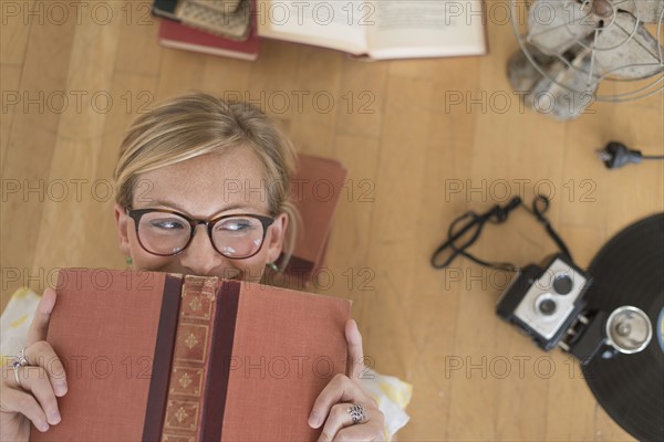 Woman lying down on floor and peeking.