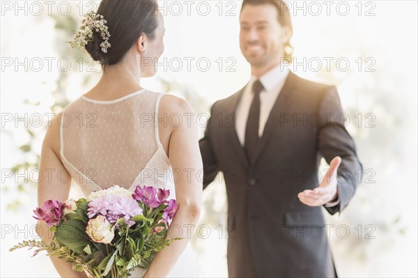 Bride and groom looking at each other. .