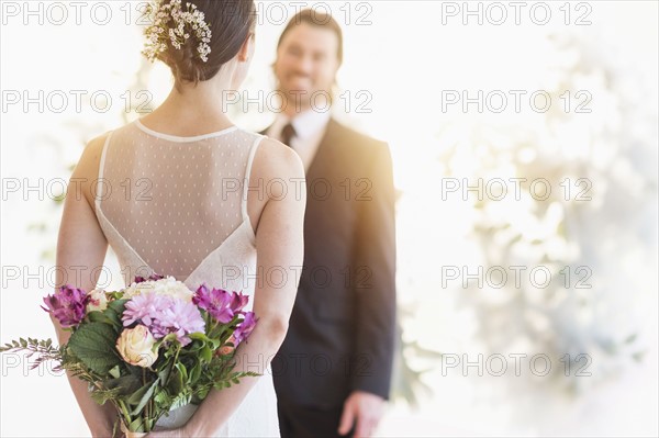 Bride and groom looking at each other. .