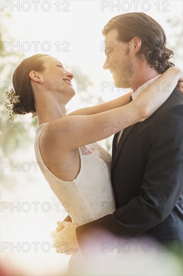 Bride and groom embracing.