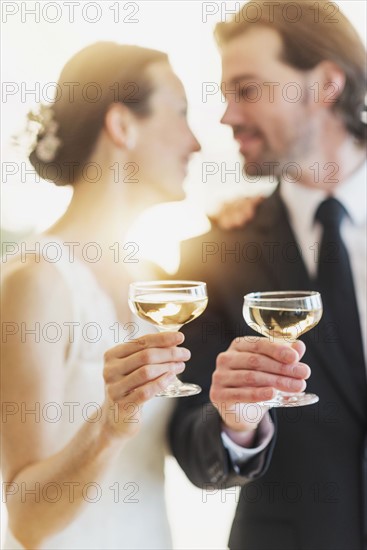 Bride and groom toasting with champagne.