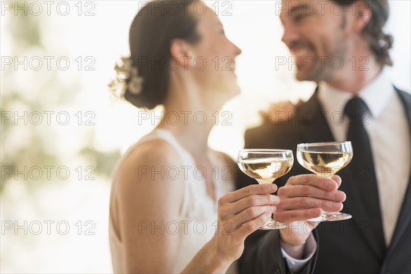 Bride and groom toasting with champagne.