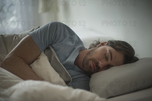 Man sleeping in bed.