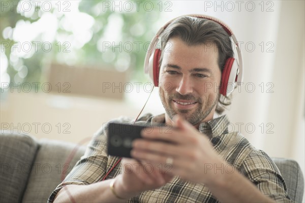 Smiling man listening to music. .