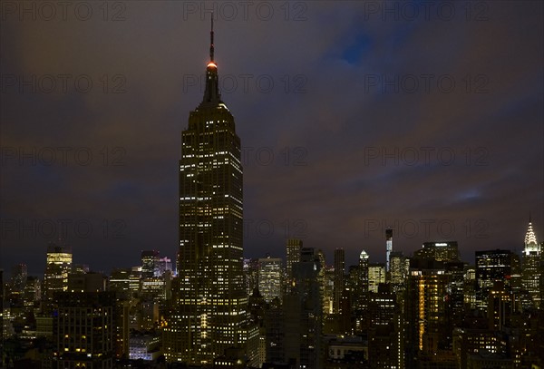 Cityscape with Empire State Building at night. New York City, New York.