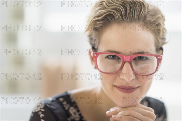 Portrait of young woman wearing glasses.