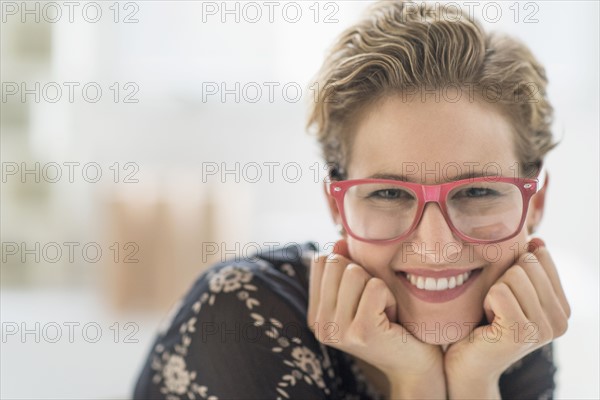 Portrait of smiling young woman wearing glasses.