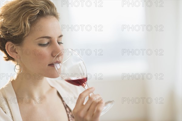 Young woman drinking red wine.