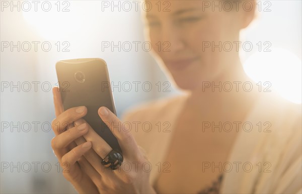 Young woman using mobile phone.