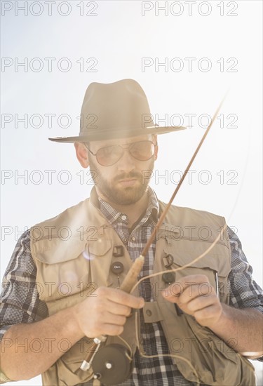 Portrait of man holding fishing rod.