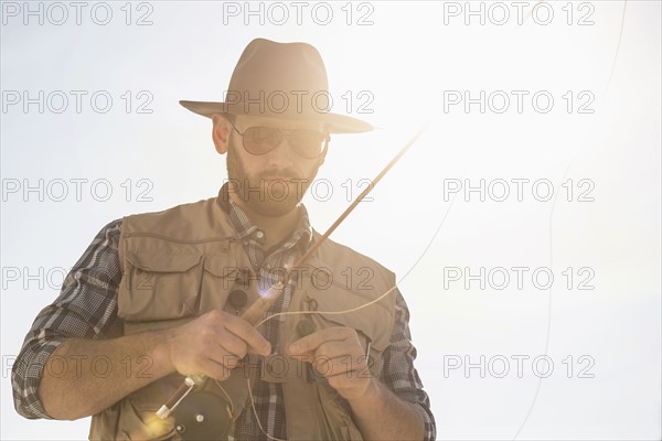 Portrait of man holding fishing rod.