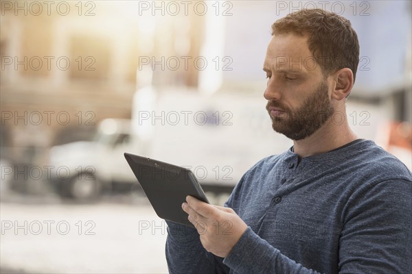 Delivery man using digital tablet.